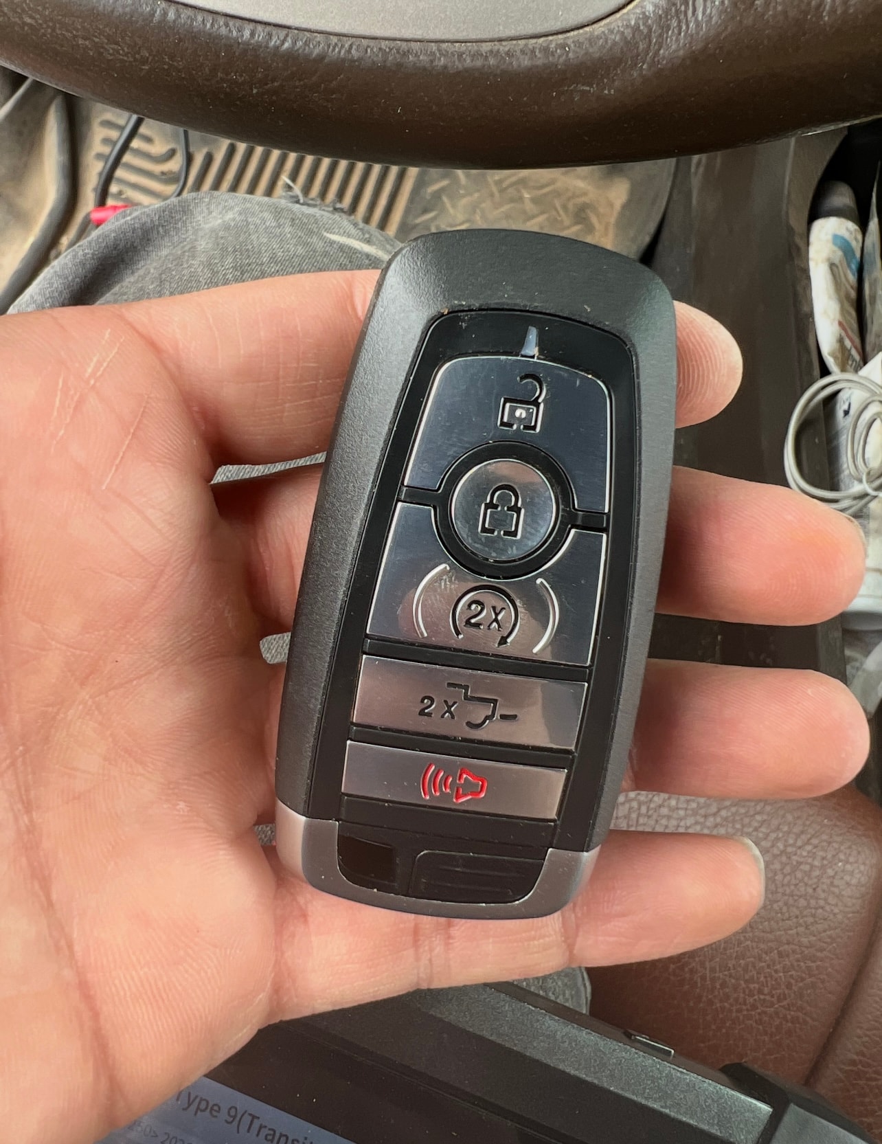 Hand holding car key fob remote
