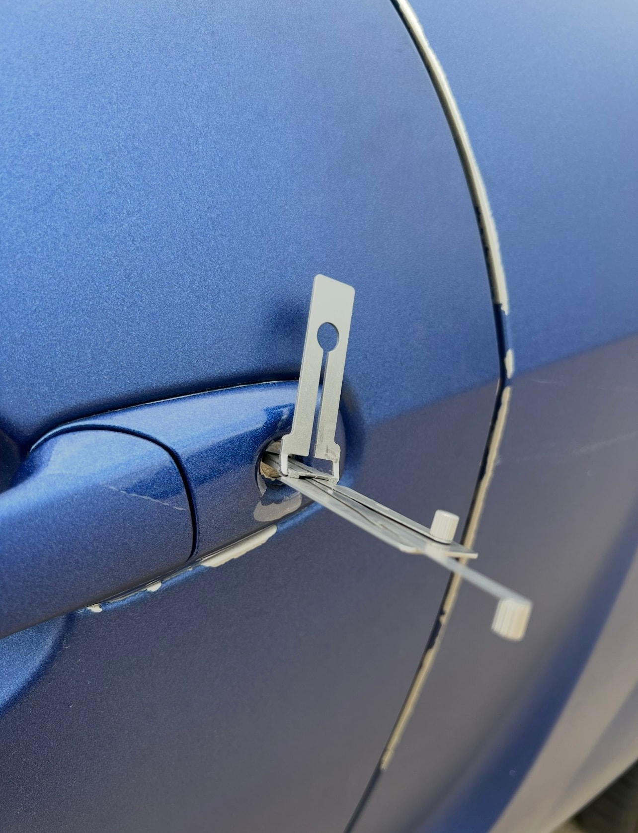 Blue car door handle detail