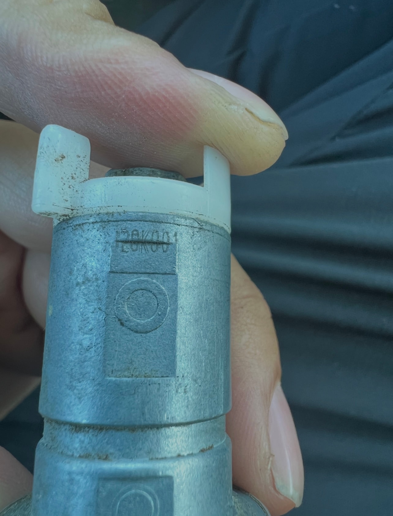 Hand holding weathered metal pipe connector