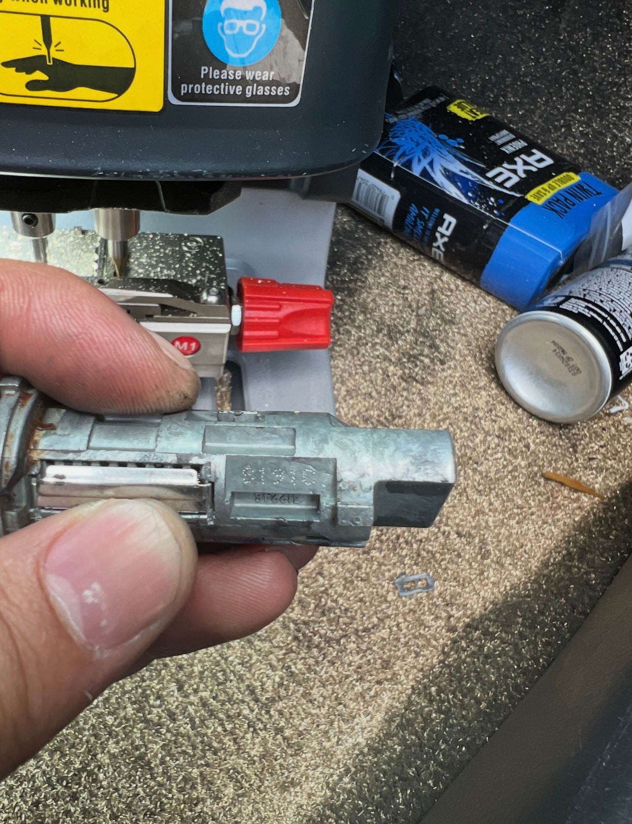 Hand holding small mechanical part in workshop