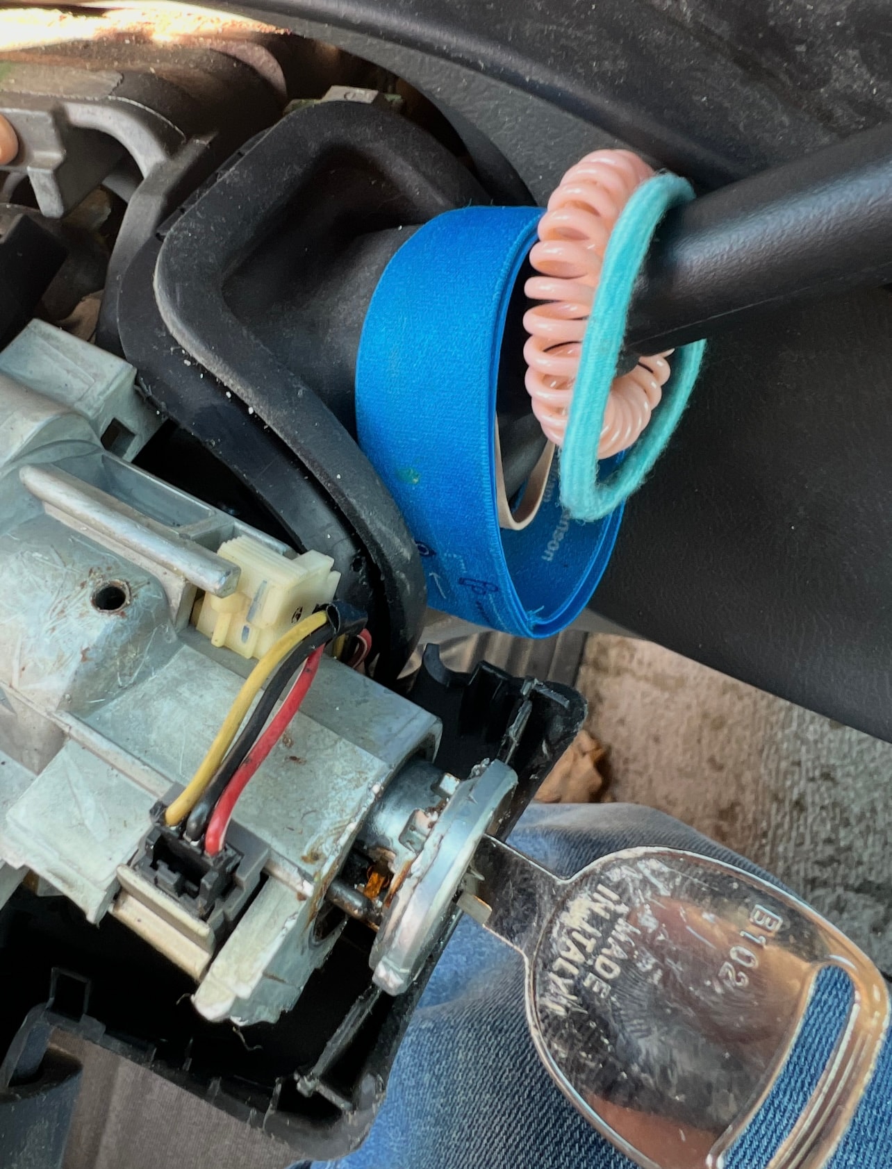 Blue duct tape wrapped around car part