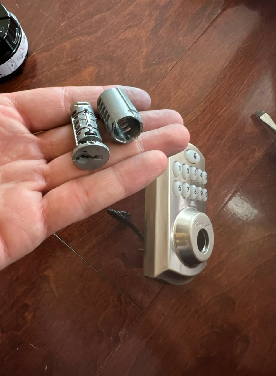 Hand holding door lock cylinders