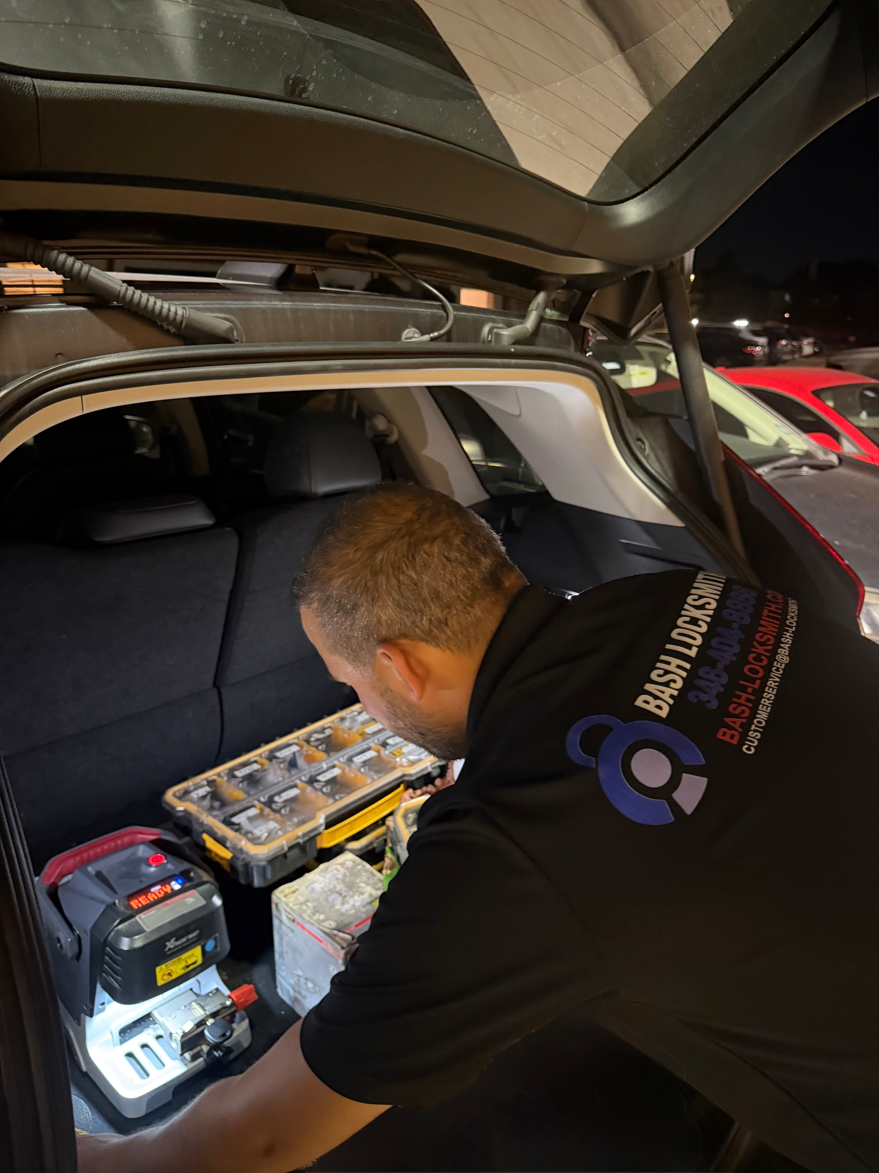 Mechanic organizing tools in car trunk
